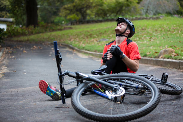 Male cyclist getting injured while falling from mountain bike