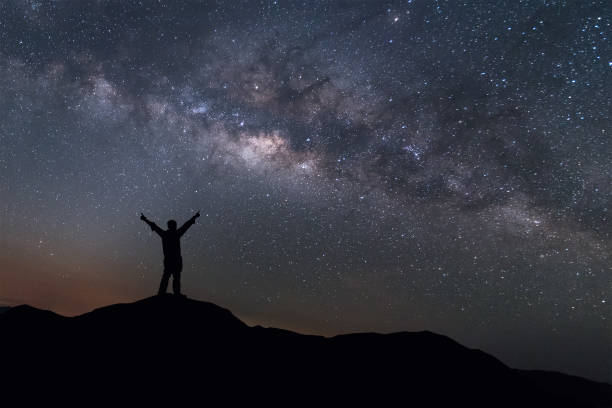 istock Milky Way landscape. Man standing on top mountain with night sky 650649288