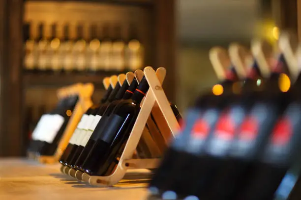 Wine bottles on a wooden shelf. Wine bar.