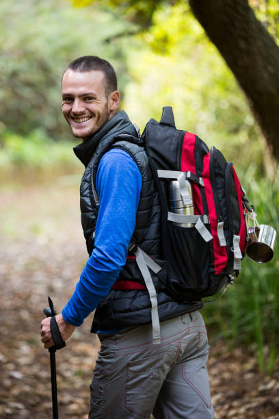 istock Smiling male hiker walking with hiking pole 650669132