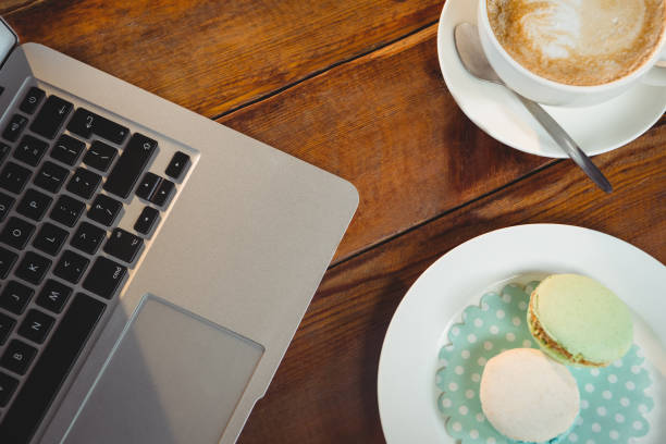 istock Cappuccino, laptop and sweet food on table 650672626