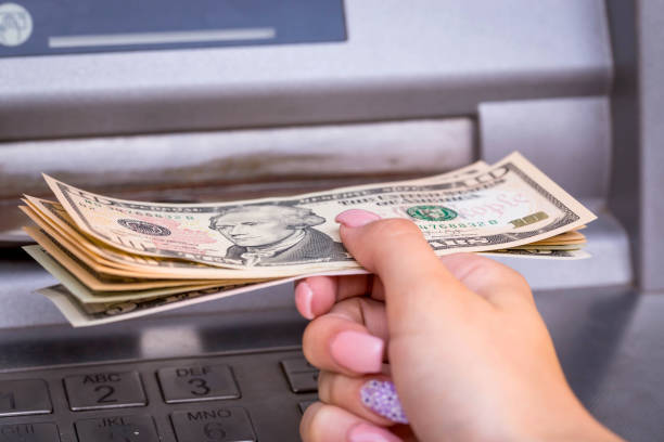 istock Woman hand withdraw american dollar 650675350