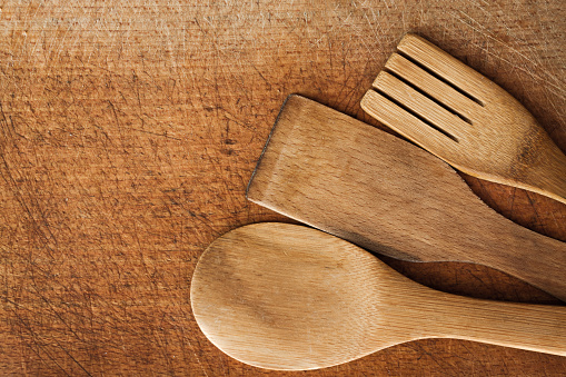 Wooden Different size Serving spoons and fork on wooden surface background