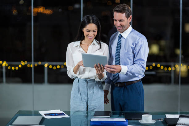 istock Businessman discussing with colleague over digital tablet 650675726