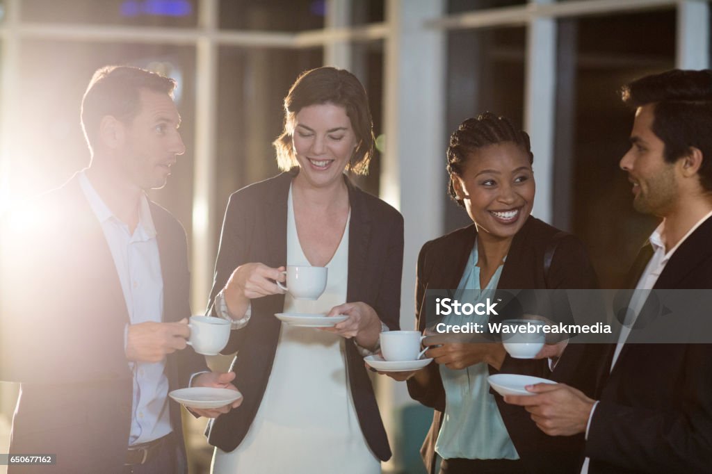 Group of businesspeople having coffee during break Group of businesspeople having coffee during break in the office Coffee - Drink Stock Photo