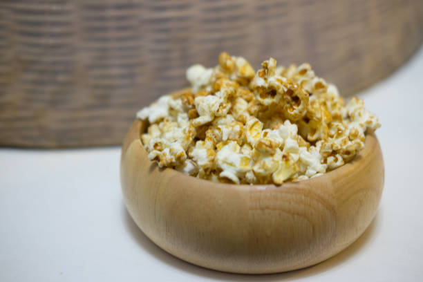 istock Bowl full of sweet popcorn on white table. Selective Focus 650683548
