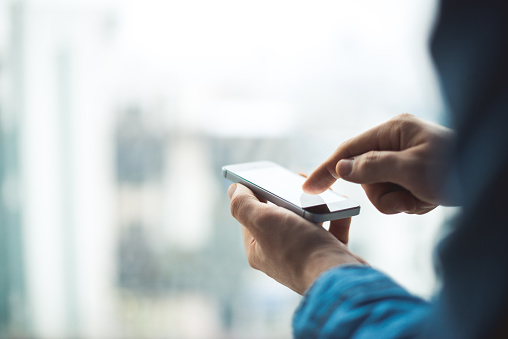 Close up of a man using a mobile phone.