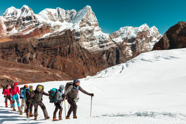 istock Mountain Panorama View and Sport Team walking up on Snow Terrain 650689630