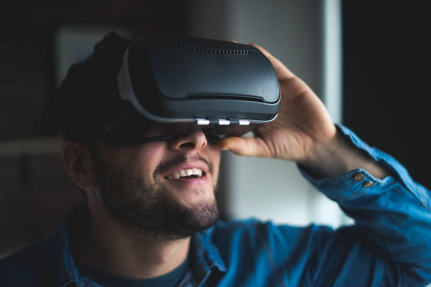 Virtual reality is fun Handsome happy man using VR headset in the office. head mounted display stock pictures, royalty-free photos & images