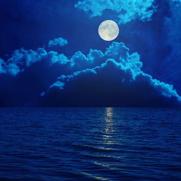 full moon in clouds over sea full moon in clouds over sea fantasy moonlight beach stock pictures, royalty-free photos & images