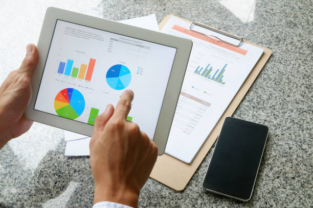istock business man hold analyzing financial chart on tablet 650695888