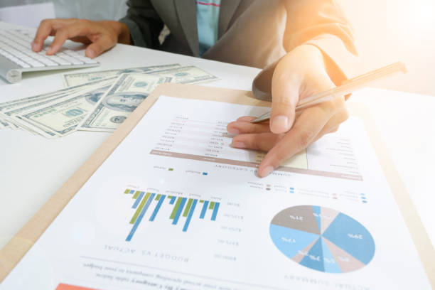 istock business woman point chart with money dollar 650696510