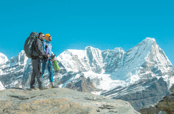istock Hikers discussing travel Rout in high Mountains 650697028