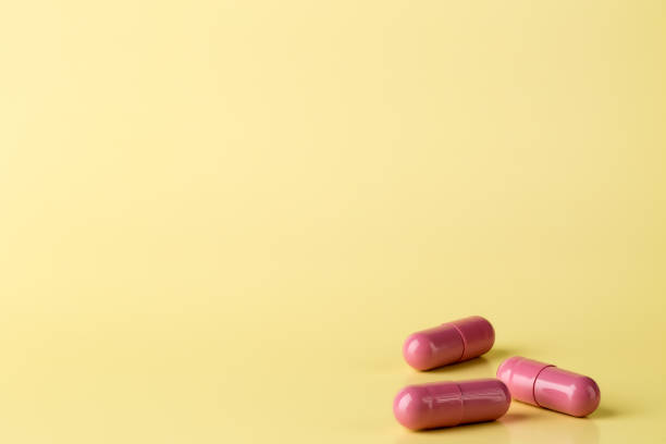 istock Red medicine pills on bright background 650697066