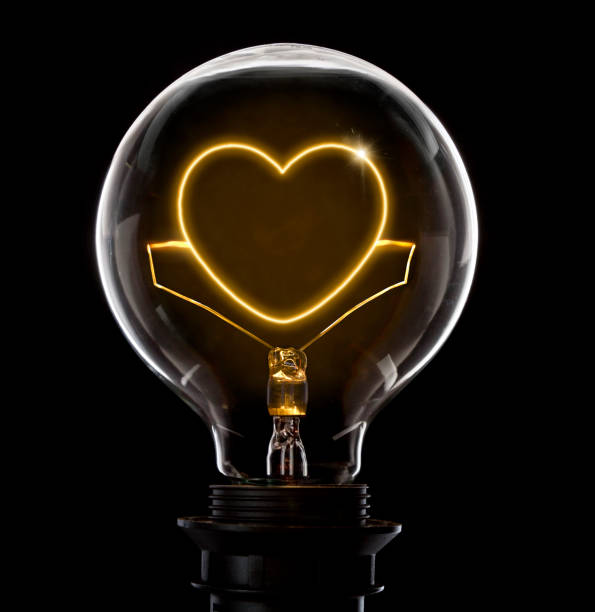 istock Lightbulb with a glowing wire in the shape of a heart (series) 650699432