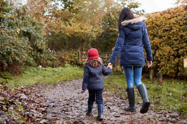 istock Mother And Daughter Holding Hands On Autumn Walk 650700500