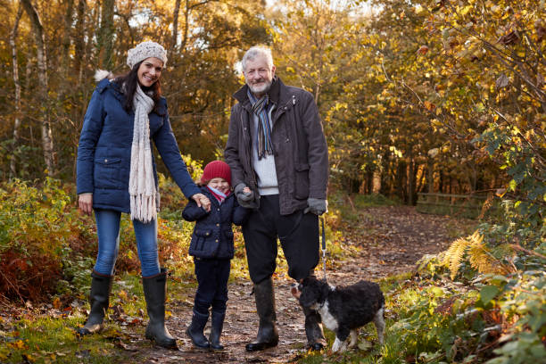 istock Multi Generation Family Take Dog For Walk In Fall Landscape 650702948