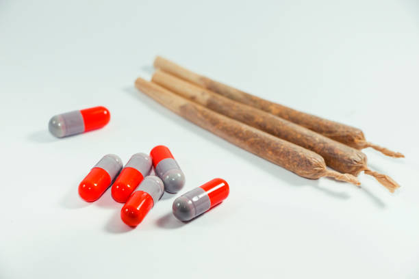 istock Marijuana and drugs, pills, narcotic on white backroung. Close up. 650706748