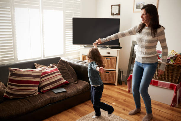 istock Daughter Dances With Mother At Home 650711046