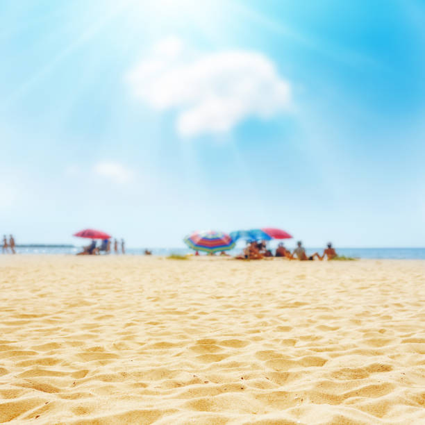 istock sand on the beach and sun in blue sky 650711324