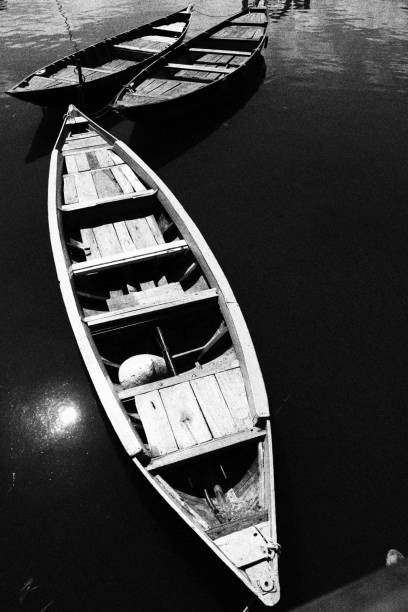The red communist party flag is seen blowing on a boat in the middle of the photo. An eye is painted on the bows to ward off sea monsters. 