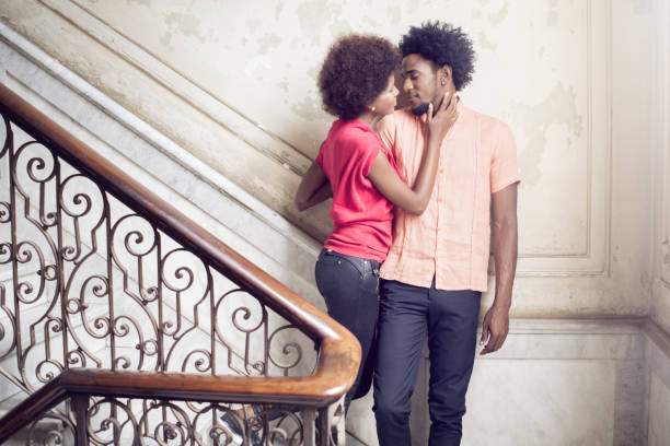 istock Young Couple standing on steps against wall, Havana, Cuba 650713728