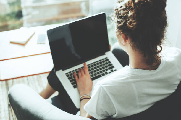 istock Woman sitting in office with laptop 650722856