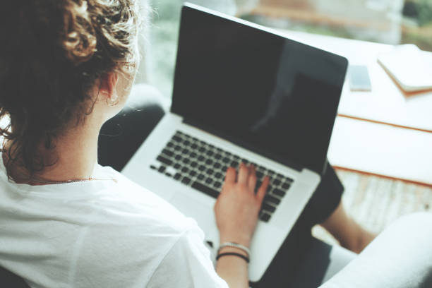 istock Woman sitting in office with laptop 650723180