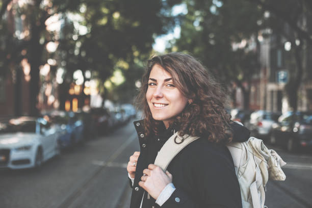 istock Woman with backpack and mobile phone in the city 650723768
