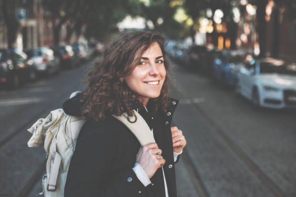 istock Woman with backpack and mobile phone in the city 650723852