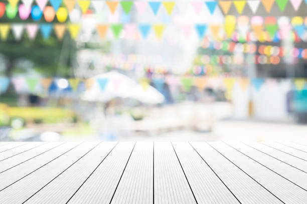 Empty wooden table with party in garden background blurred. stock photo