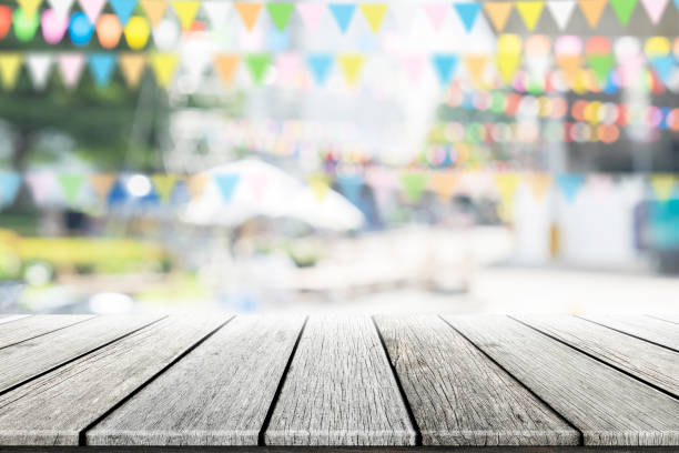 istock Empty wooden table with party in garden background blurred. 650729842
