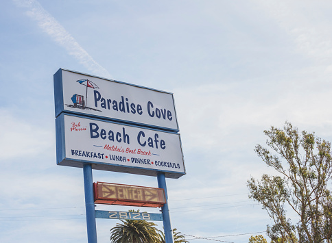 An editorial stock photo of the road sign for Paradise Cove in Malibu, California. Paradise cove is a famous beach in Malibu.