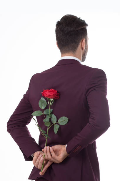 istock Man hiding roses from his back for his girlfriend 650731682