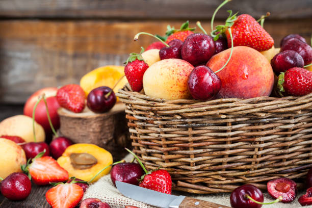 Fresh ripe summer berries and fruits Fresh ripe summer berries and fruits (peaches, apricots, cherry and strawberry) in wicker basket produce basket stock pictures, royalty-free photos & images