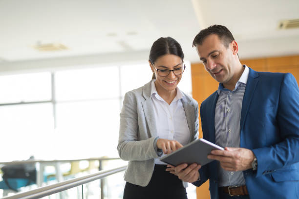istock Two business people discussing business strategy using digital tablet 650737876