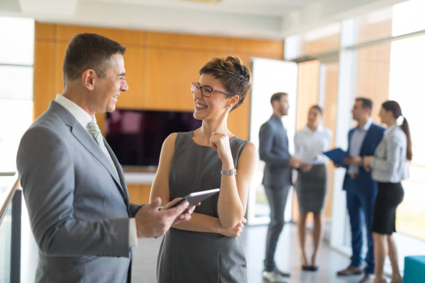 istock Two business people discussing business strategy using digital tablet 650739634