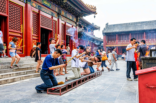 Beijing, China - August 18, 2011: Worshipers at the Yonghe Temple. Also known as the Lama Temple, is a monastery of the Gelug school of Tibetan Buddhism located in Dongcheng District, Beijing, China