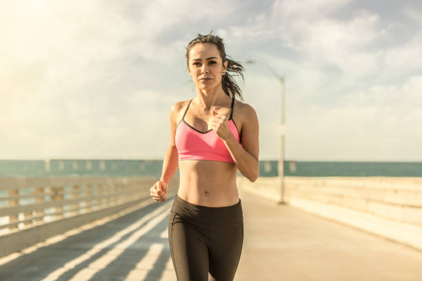 istock Young Women Runner On Ocean Beach Pier 650773270