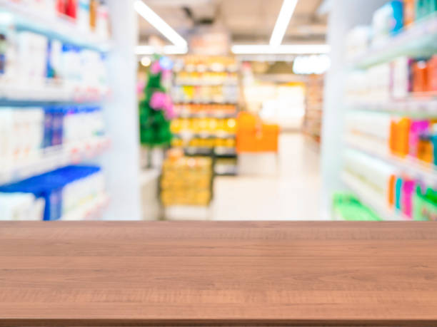 istock Wooden empty table in front of blurred supermarket 650795432