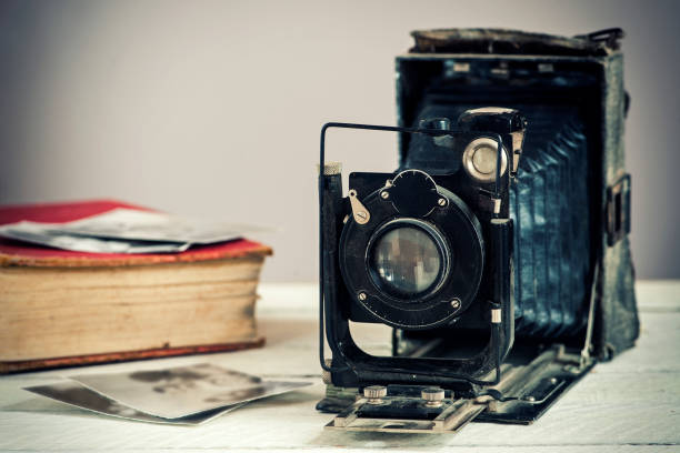 istock Vintage camera on a wooden background 650795488