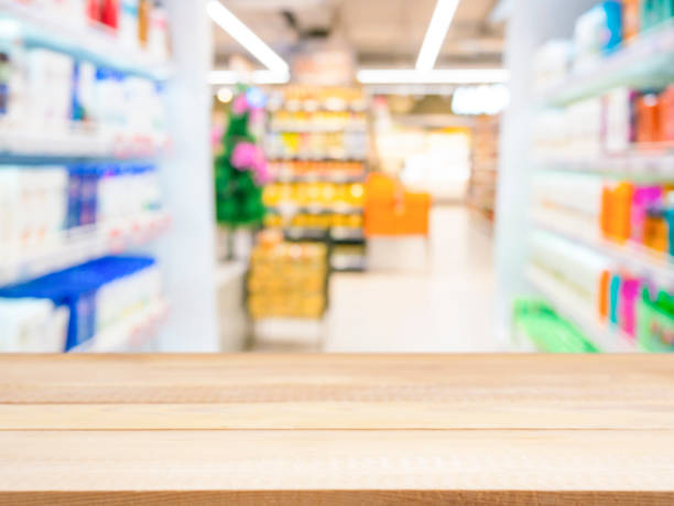 istock Wooden board empty table over blur in supermarket 650796020