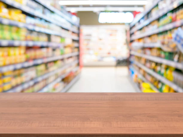 istock Wooden empty table in front of blurred supermarket 650800716