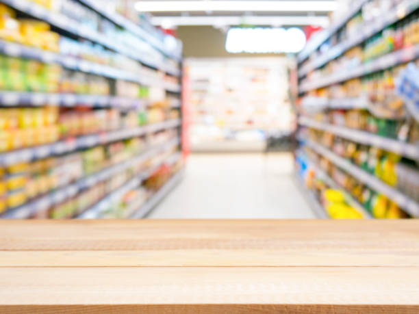 istock Wooden empty table in front of blurred supermarket 650801274