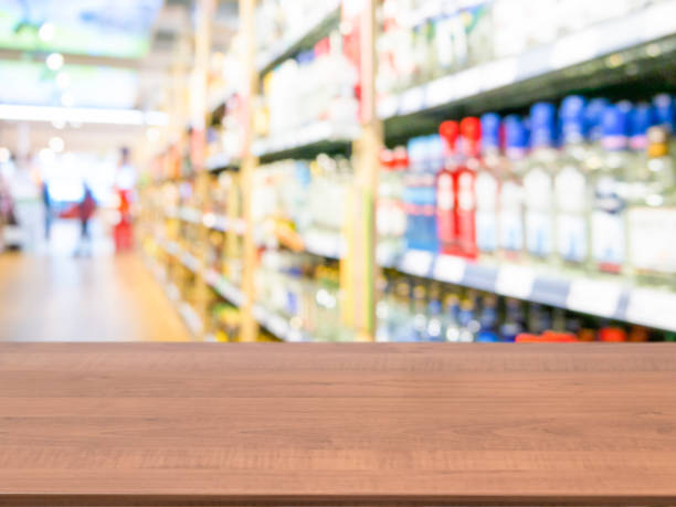istock Brown wooden empty table in front of blurred supermarket 650803392