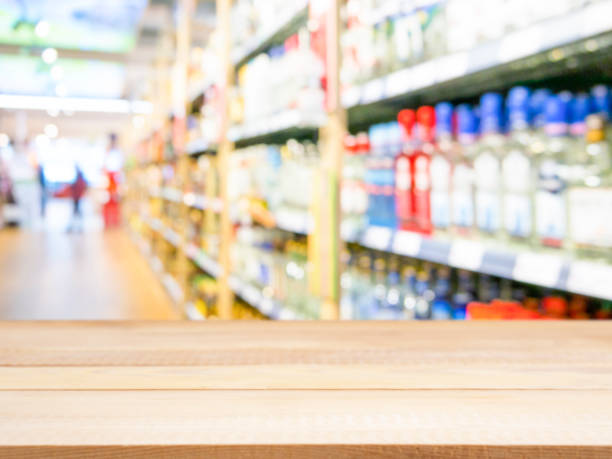 istock Light wooden empty table in front of blurred supermarket 650803974