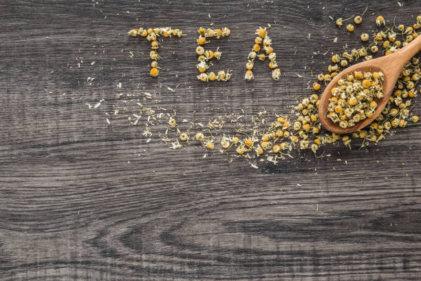 istock Word tea created from chamomile. Healthy drink. Chamomile herbal tea. 650805460