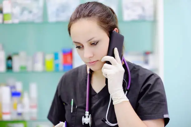 Photo of Female medical worker using cell phone