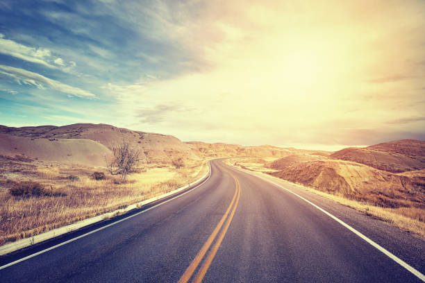 Vintage toned scenic desert highway at sunset, travel concept, USA.
