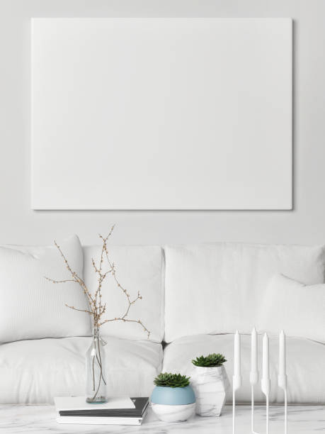 istock Mock up poster above white sofa, hipster living room 650875456